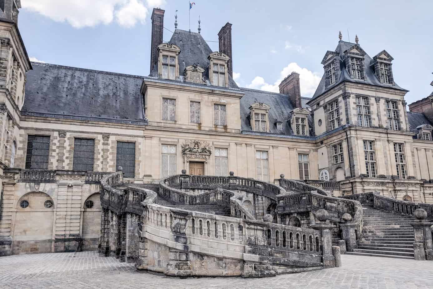 Exterior of Fontainebleau Chateau with horseshoe staircase leading to the former main entrance.