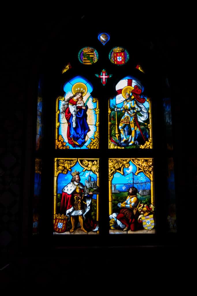 Stained Glass window depicting scenes from Portugal's history and the birth of Jesus.
