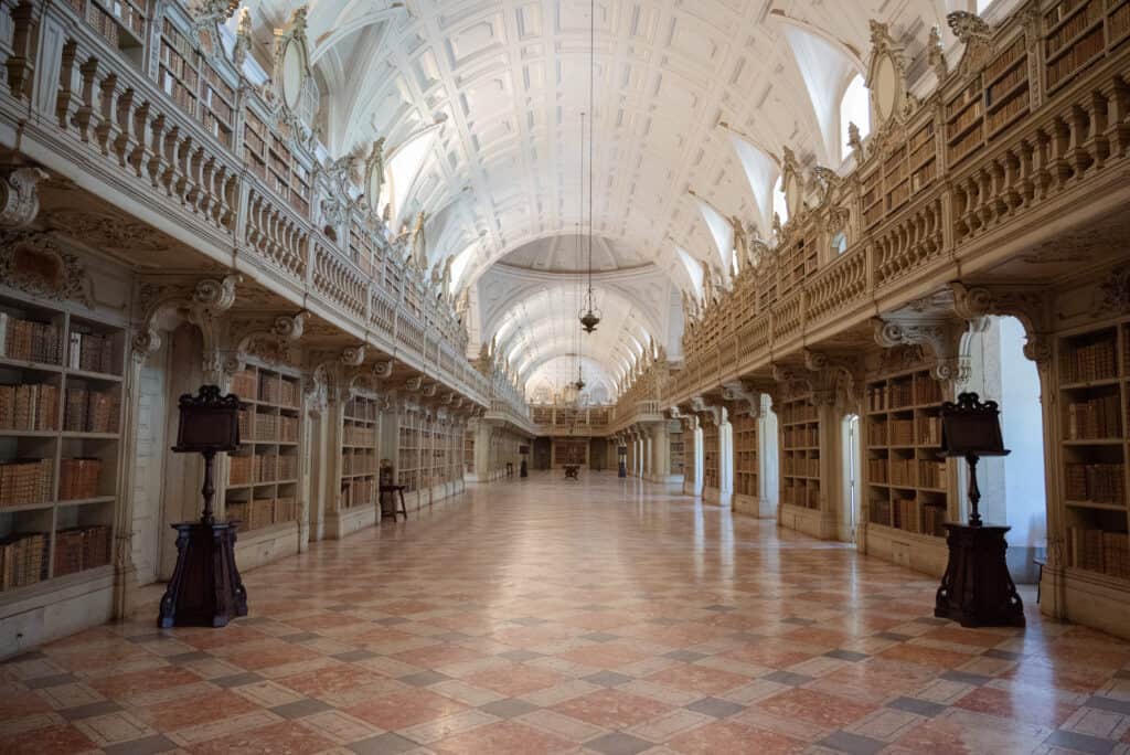 Library at Mafra- Long room with books and elaborate wood bookshelves