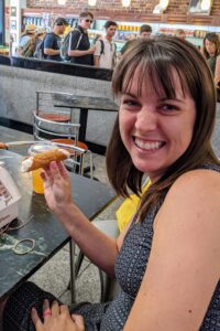 Jami eating a cannoli in Boston