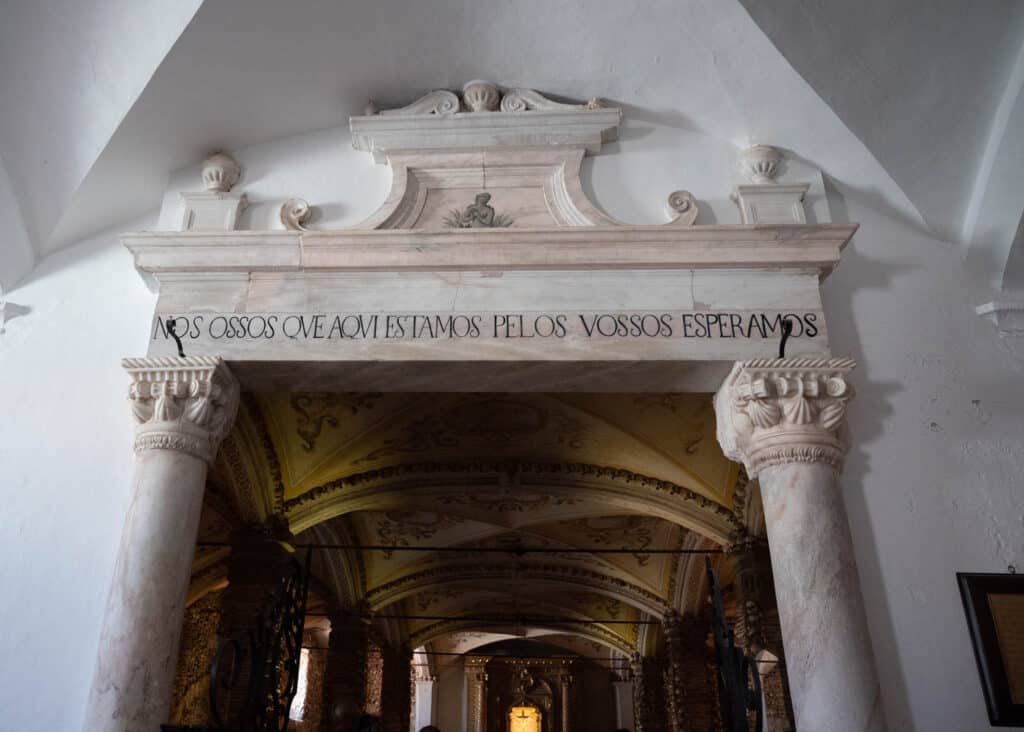 Doorway to Évora Chapel of Bones with "Nos Ossos Que Aqui Estamos Pelos Vossos Esperamos" inscribed