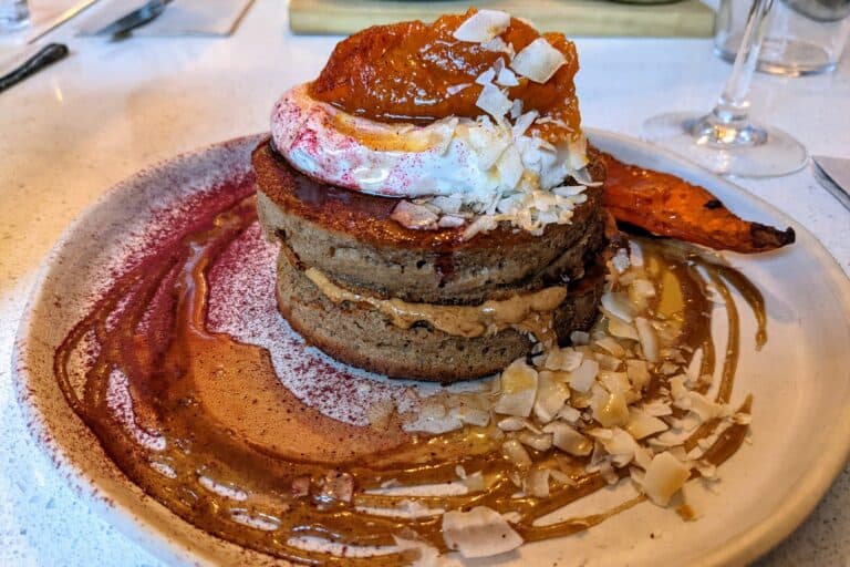 Gluten-free pumpkin pancakes with almonds, cream, and pumpkin puree