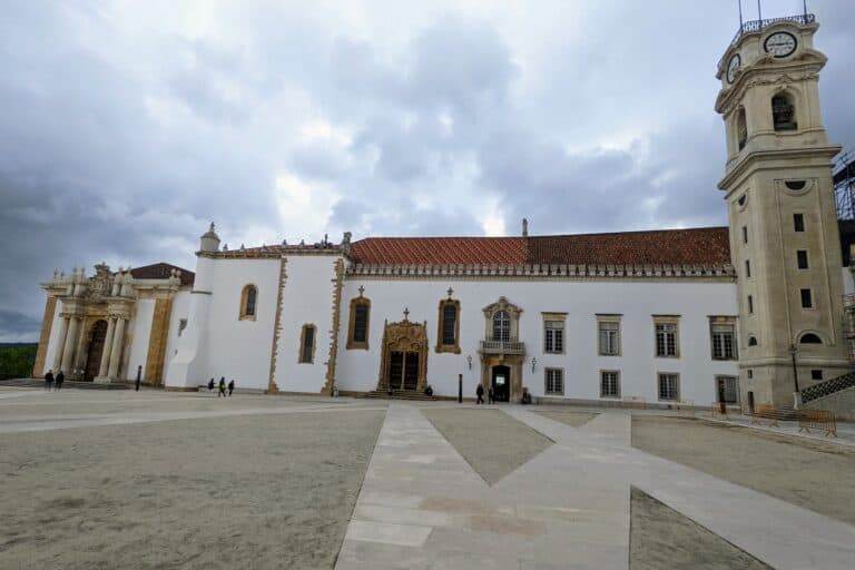 University in Coimbra- White building with brown stone accent and red tile roof