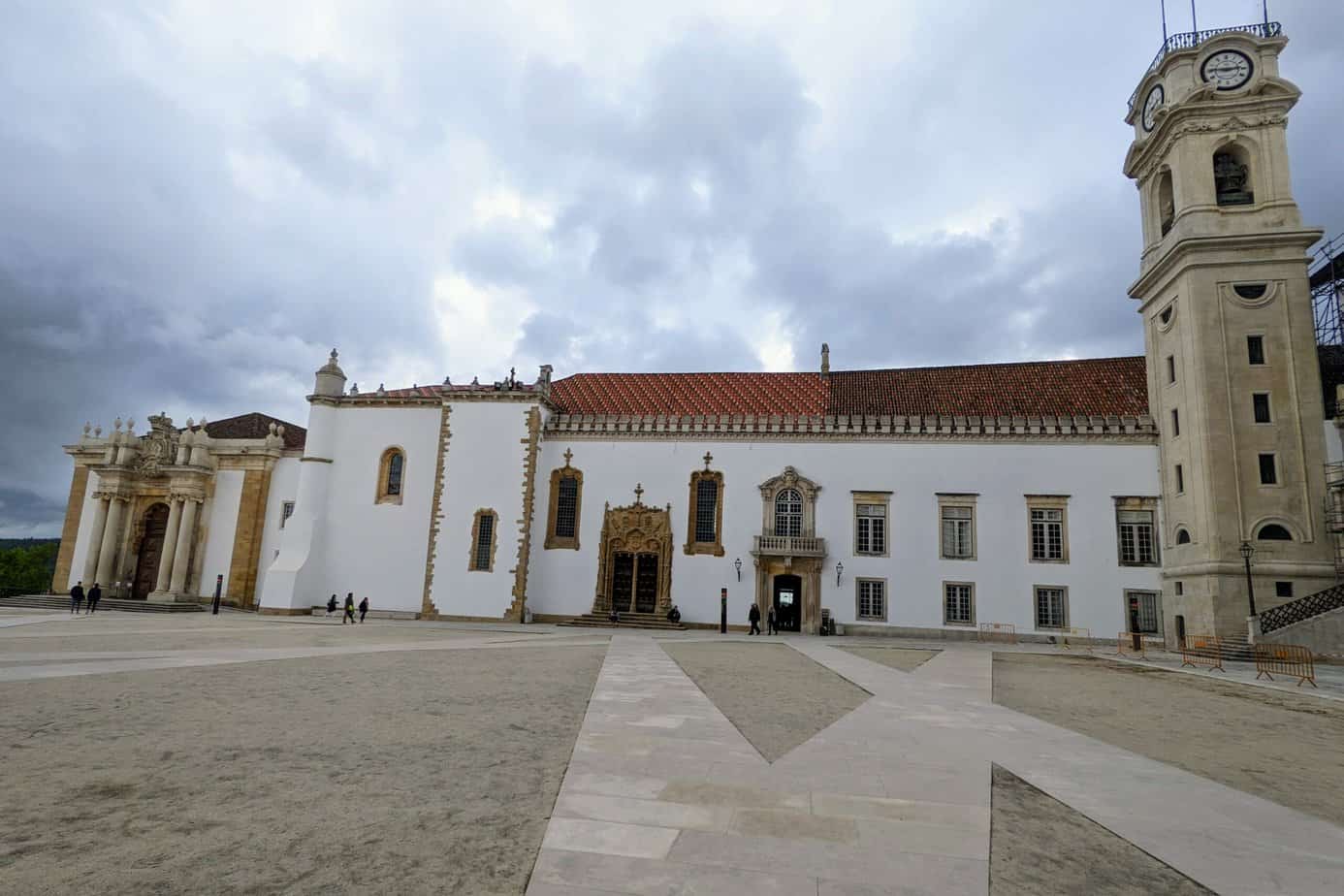University in Coimbra- White building with brown stone accent and red tile roof