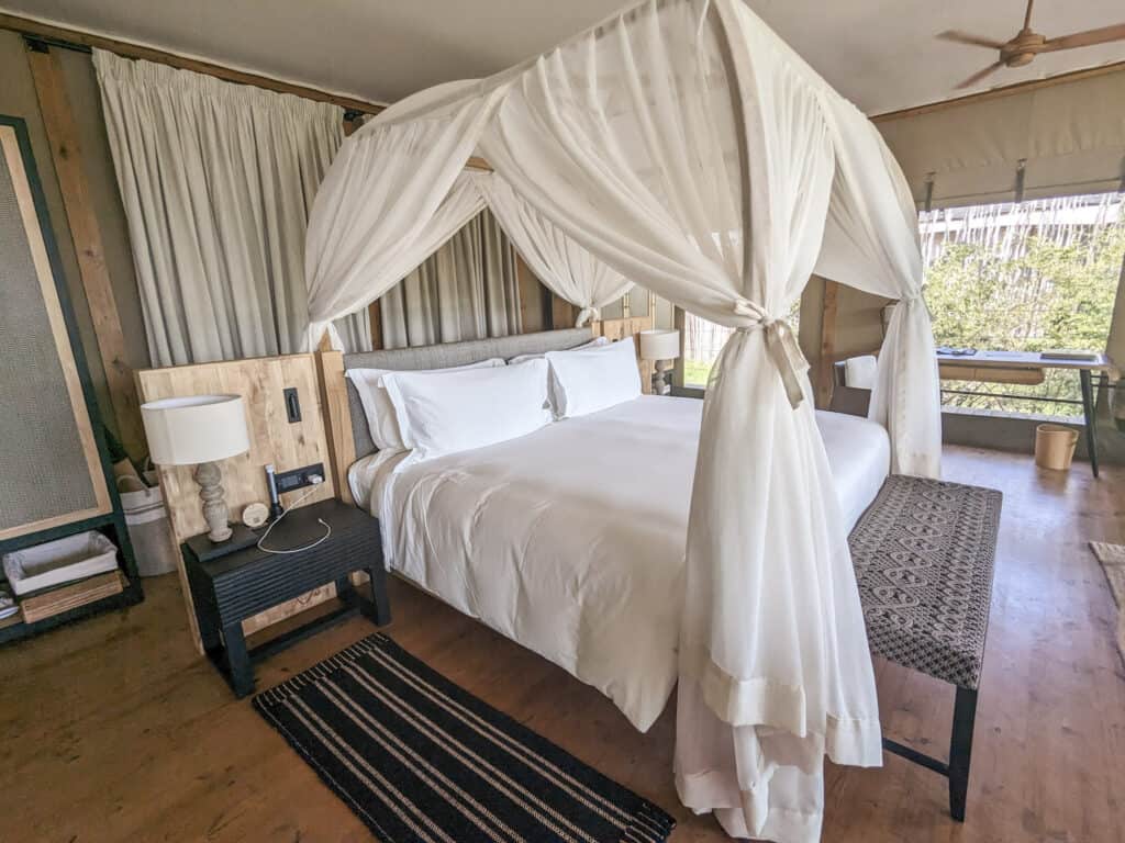 Canopy bed and night main room of JW Marriott Masai Mara tent.